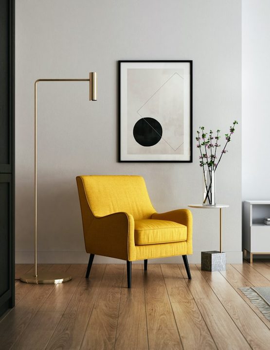 Styled corner with a mustard armchair and floor lamp